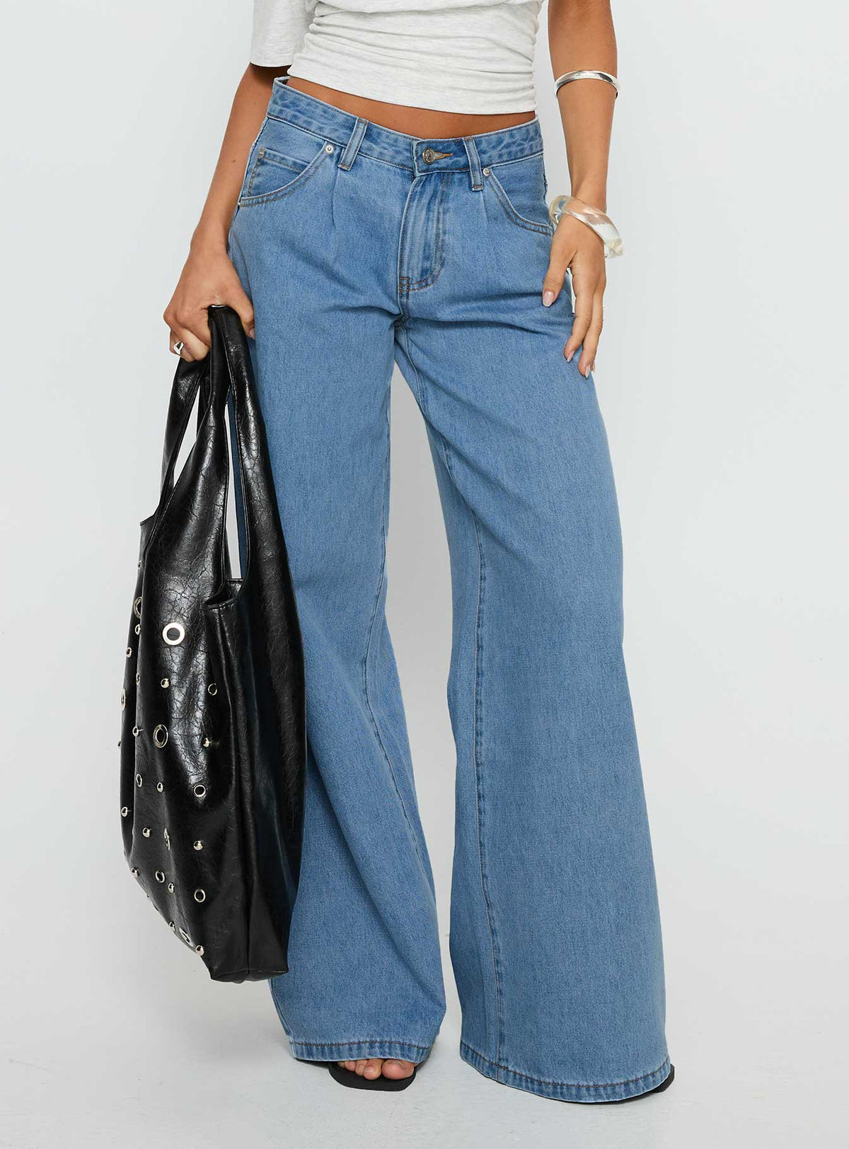 back view of model wearing Princess Polly Supercut Low Rise Baggy Pleat Jeans Light Blue Wash Low Rise Jeans Jeans 