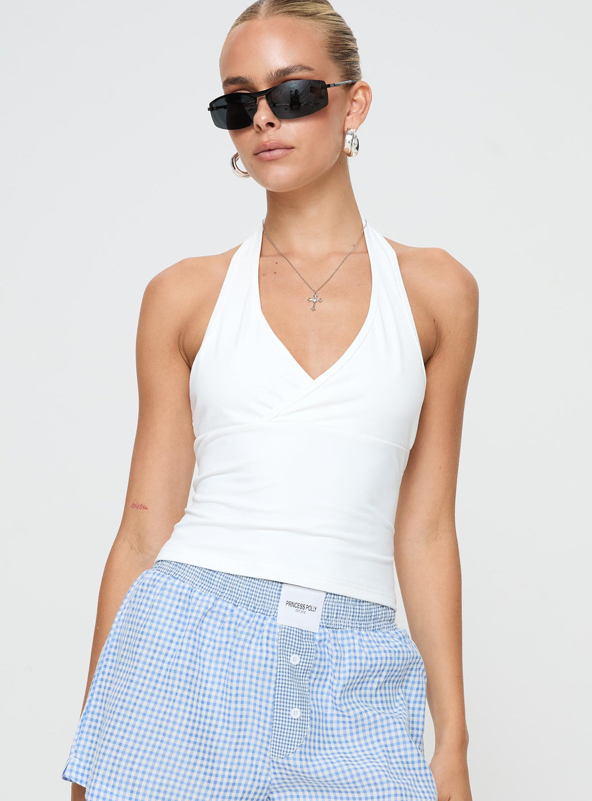 front view of model wearing Princess Polly Stand By Halter Top White Sleeveless Plunger 