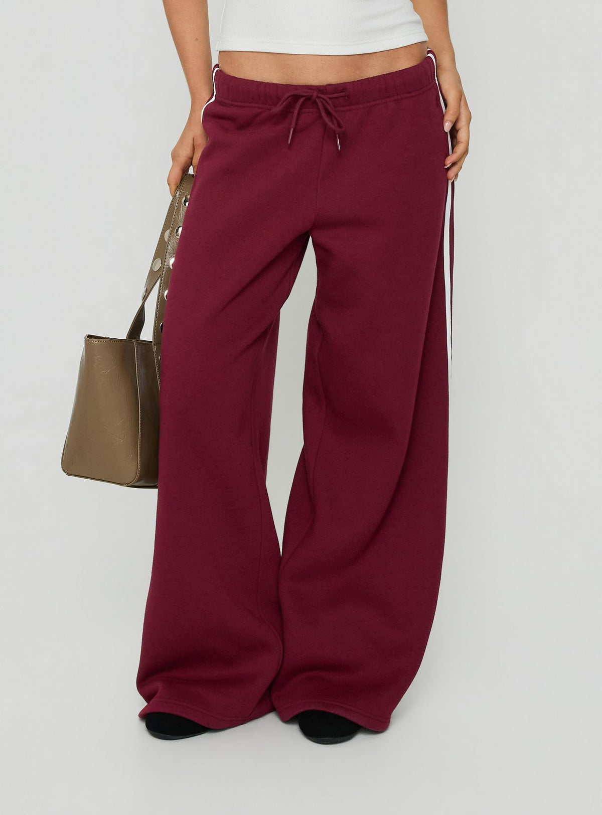 Featuring the Kennah Wide Leg Sweat Pants Cherry in womens-regular-pants with mid-rise design side view of model wearing Princess Polly