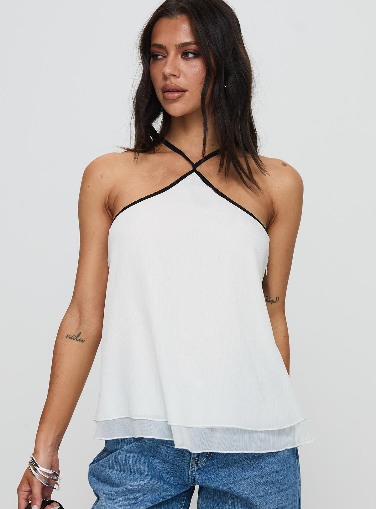 front view of model wearing Princess Polly Rafaella Halter Top Cream Sleeveless Asymmetric Neckline 