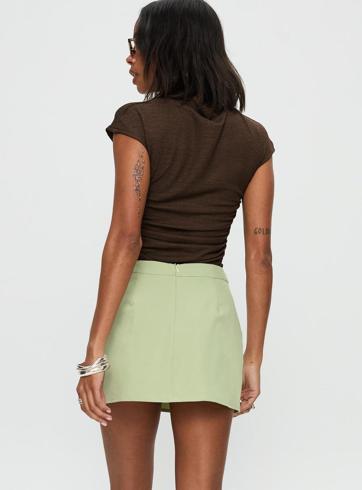 back view of model wearing Princess Polly Hosier Twill Mini Skirt Green Skirts 
