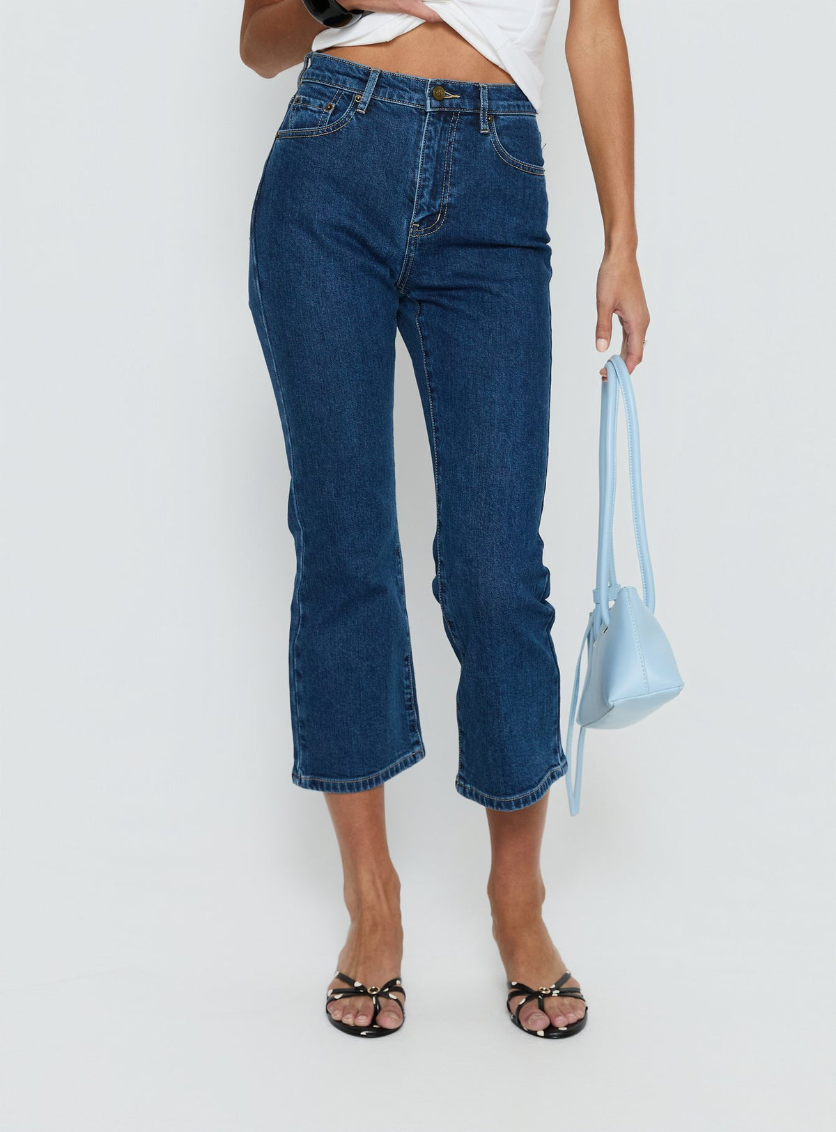 side view of model wearing Princess Polly Cindee High Rise Cropped Jeans Mid Blue Wash High Rise Jeans Jeans 