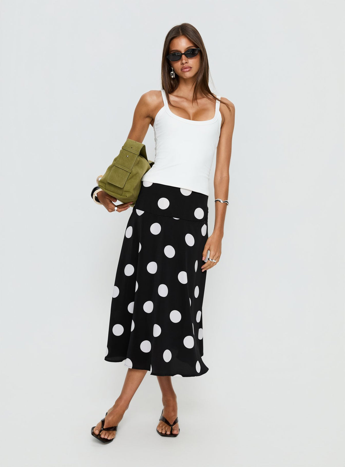   side view of model wearing Princess Polly Picture It Midi Skirt Black Polka Dot Midi Skirts Skirts 