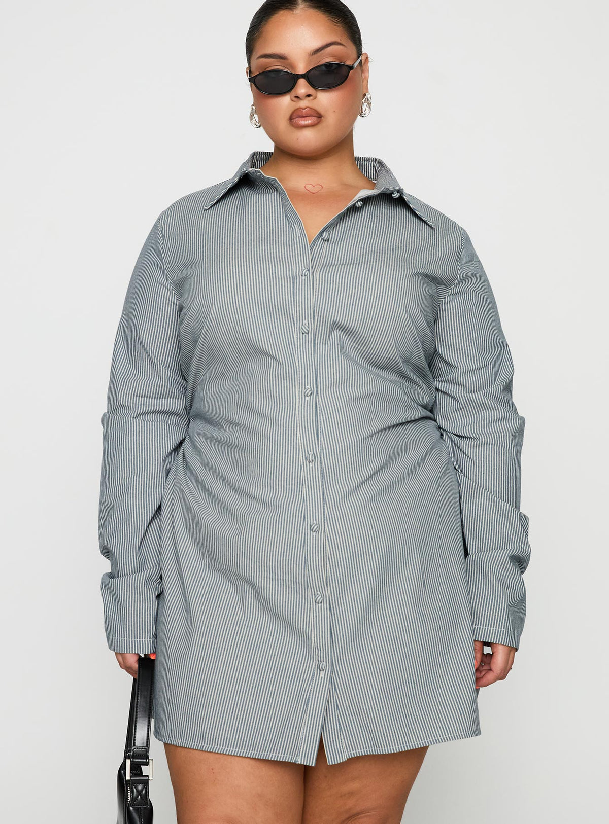 side view of model wearing Princess Polly Publicity Long Sleeve Mini Dress Blue Pinstripe Curve V-Neck 