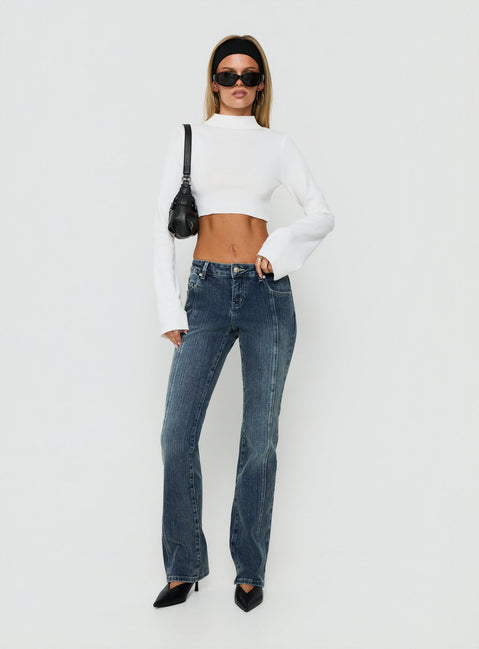 Showcasing Palaces Low Rise Ringspun Bootleg Jeans Dark Indigo womens-jeans side view of model wearing Princess Polly