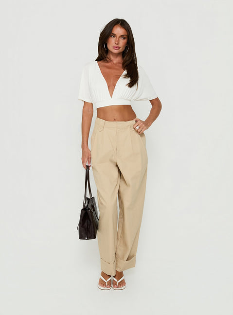 Featuring the Kendall Pant Sand womens-regular-pants with high-rise pleated wide-leg design front view of model wearing