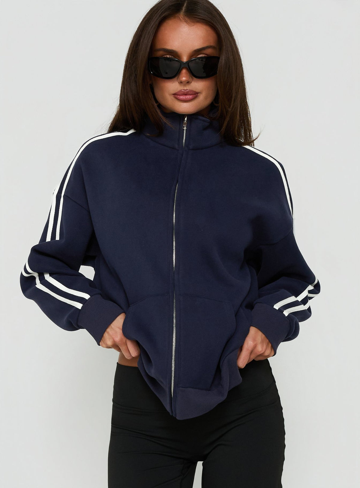 Crafted from fleece, the Keeran Funnel Neck Jumper Navy / White in womens category with short length side view of model wearing Princess Polly