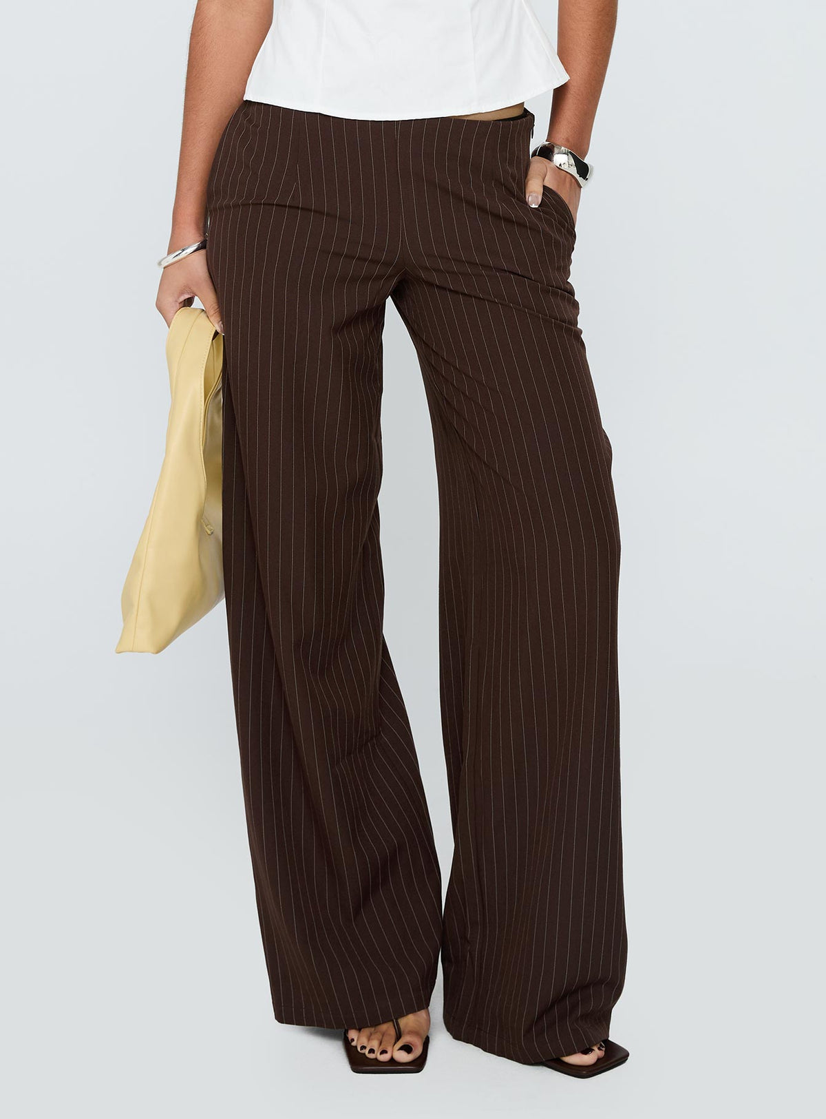 side view of model wearing Princess Polly Khane Low Rise Wide Leg Pant Brown Pinstripe Low Rise Pants Pants 