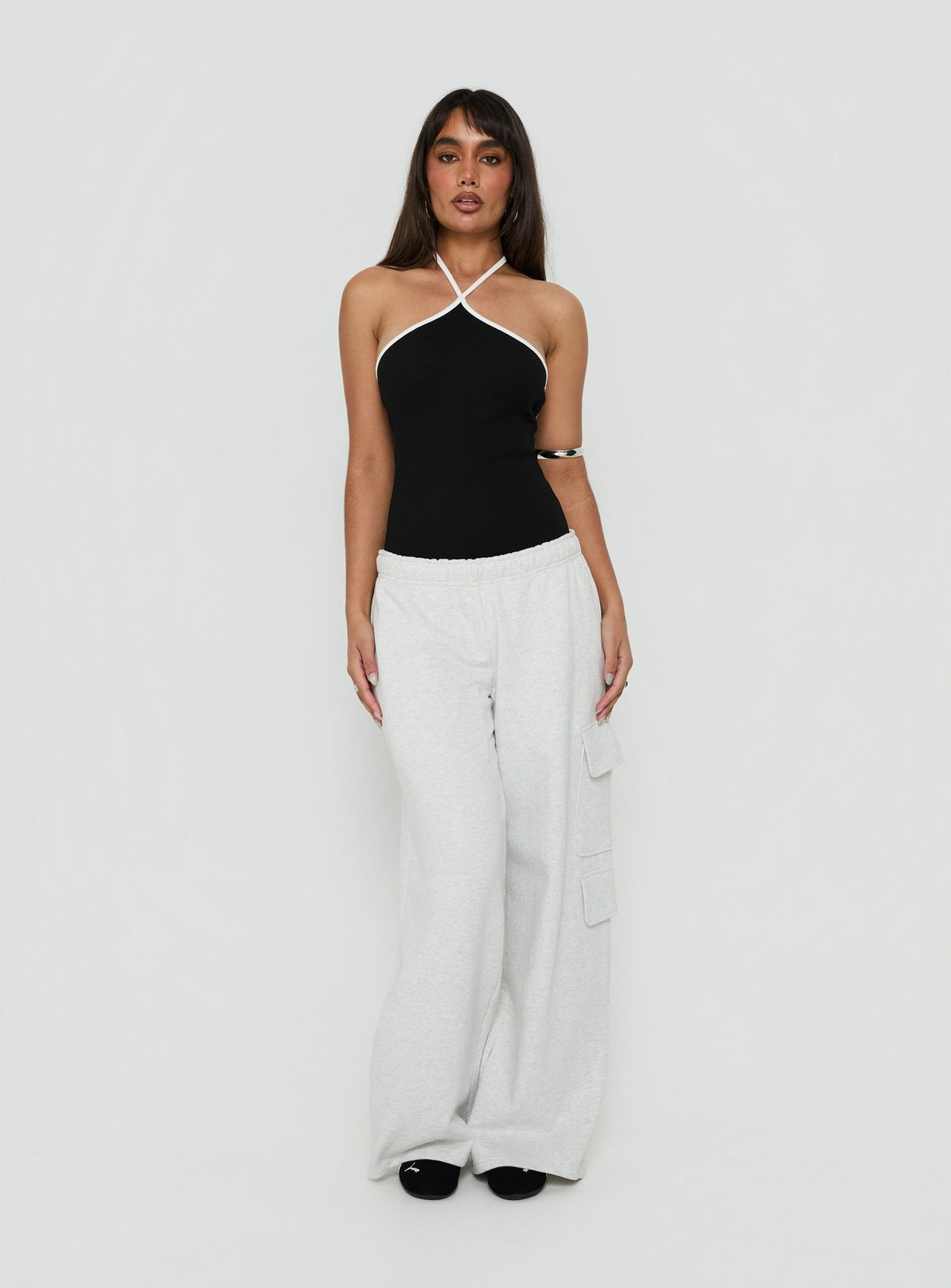 Showcasing the Azara Contrast Arrowneck Bodysuit Black / White womens-bodysuit with sleeveless design front view of model wearing Princess Polly