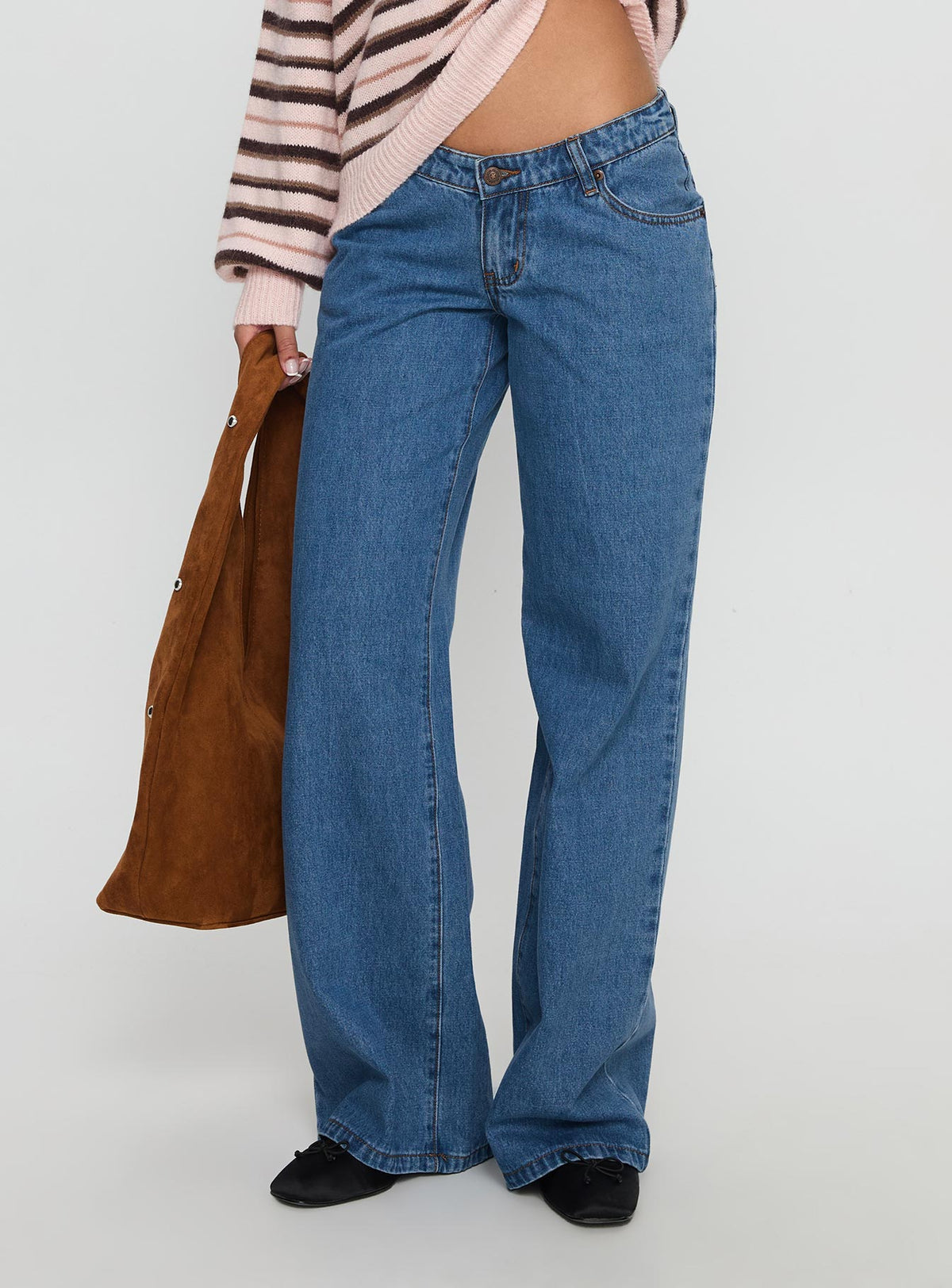 side view of model wearing Princess Polly Highlands Low Rise Wide Leg Jeans Mid Blue Wash Low Rise Jeans Jeans 