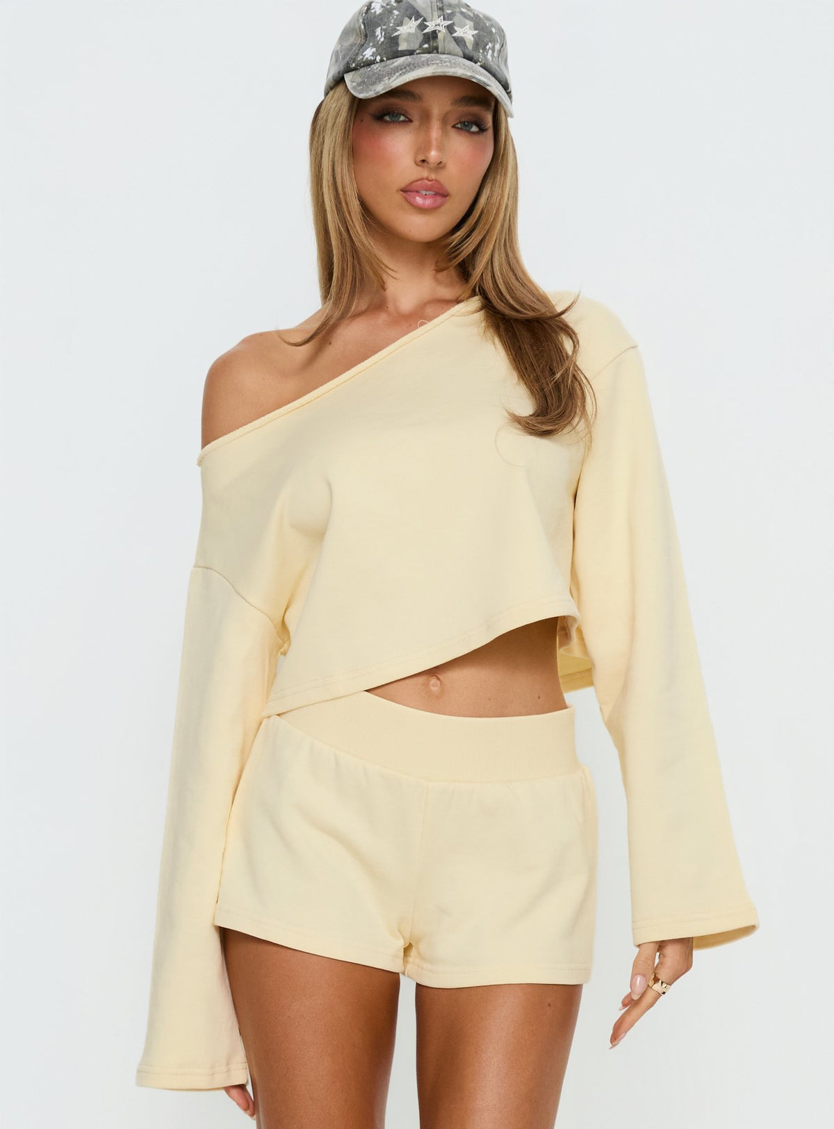 Featuring the Retreat Raw Edge Off Shoulder Jumper Buttercream womens-jumpers with short length detail view of model wearing Princess Polly