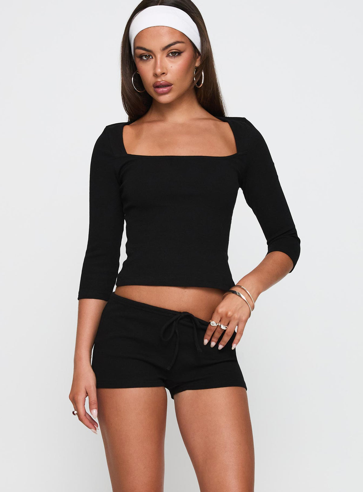 front view of model wearing Princess Polly Gracious Low Rise Mini Short Black Low Rise Shorts 