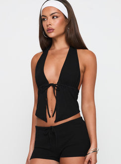 side view of model wearing Princess Polly Obviously Halter Top Black Sleeveless Plunger 