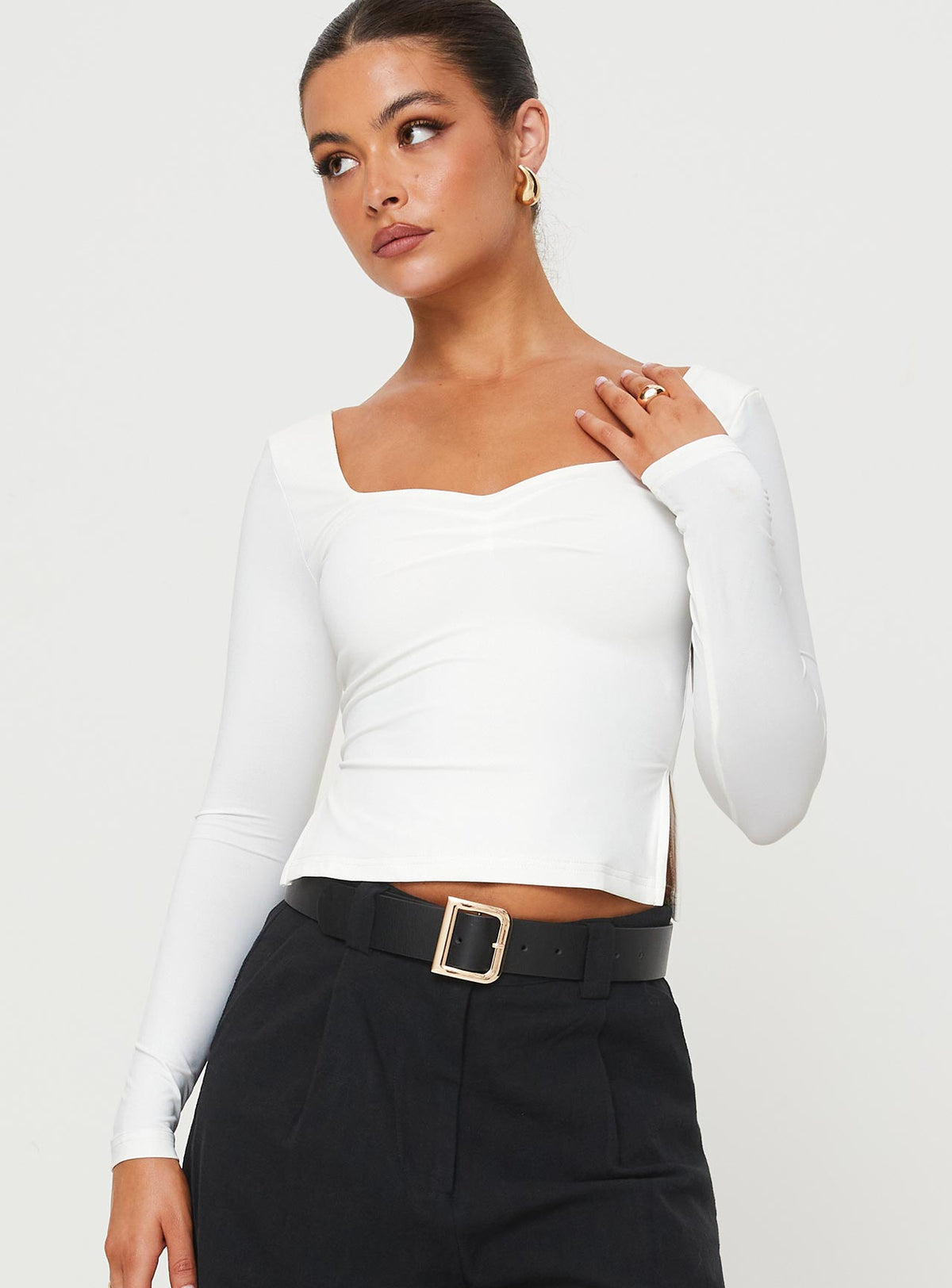 Front view of model wearing  front Princess Polly Full Sleeves Asymmetric Neckline  Rehna Long Sleeve Top White