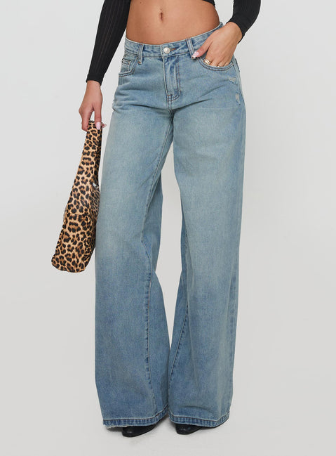side view of model wearing Princess Polly Demie Mid Rise Wide Leg Jeans Light Blue Wash Low Rise Jeans Jeans 