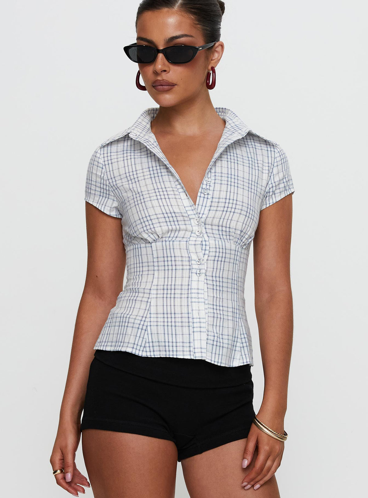 front view of model wearing Princess Polly Cottesloe Blouse Top Blue Check Short Sleeves V-Neck 