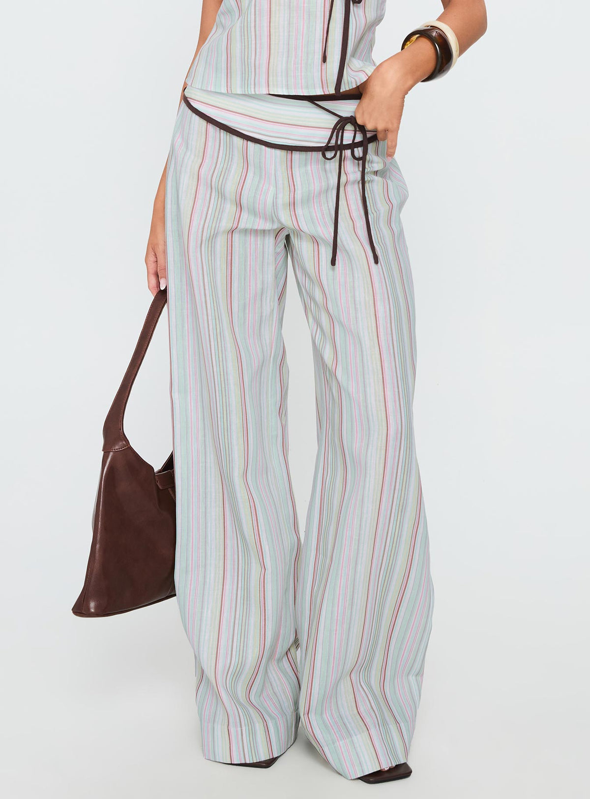 back view of model wearing Princess Polly Taylar Thick Waistband Tie Pants Green Stripe High Rise Pants Pants 