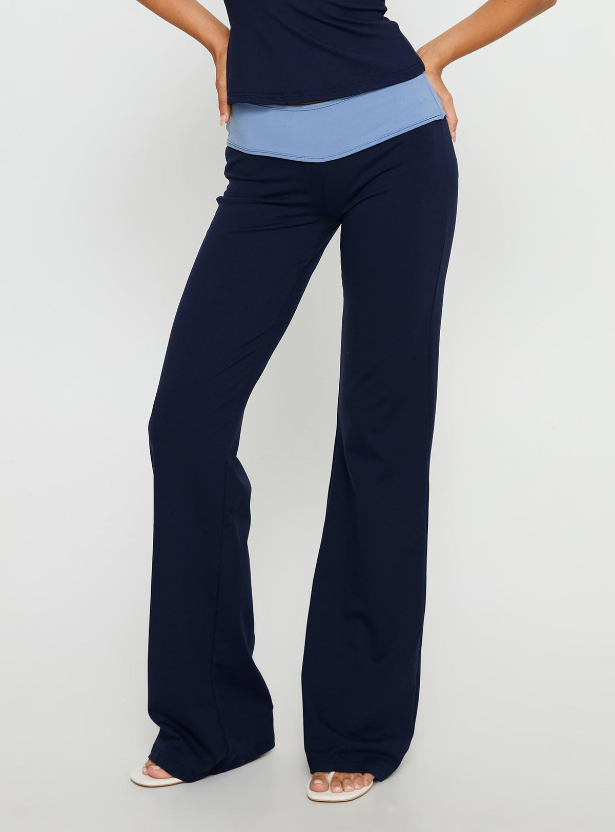 side view of model wearing Princess Polly Kobee Jersey Flare Pants Navy / Light Blue High Rise Pants Pants 