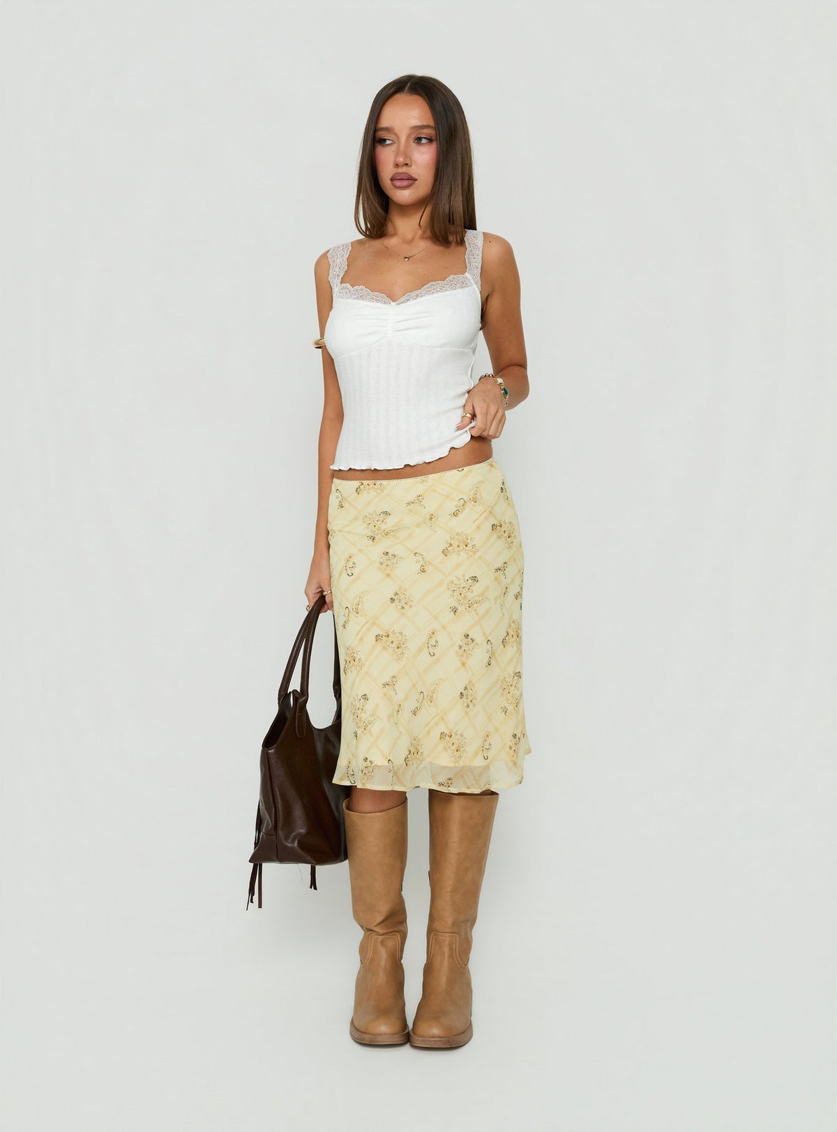 Featuring the Evina Picot Trim Midi Skirt Yellow Paisley womens-skirts with a-line shape, frill details, fitted silhouette, frayed hem, and midi length front view of model wearing Princess Polly