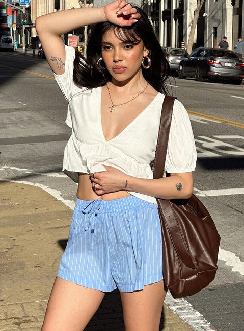side view of model wearing Princess Polly Maxxy Boxer Shorts Blue Stripe High Waisted Shorts 