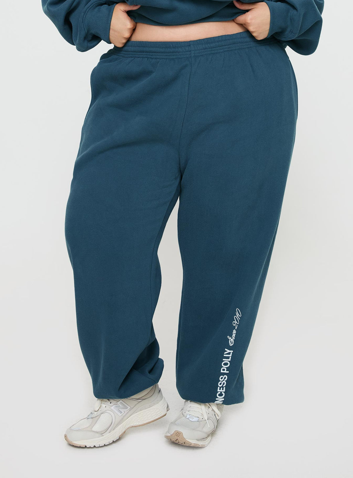 front view of model wearing Princess Polly Princess Polly Track Pants Block / Cursive Text Slate Curve Pants 