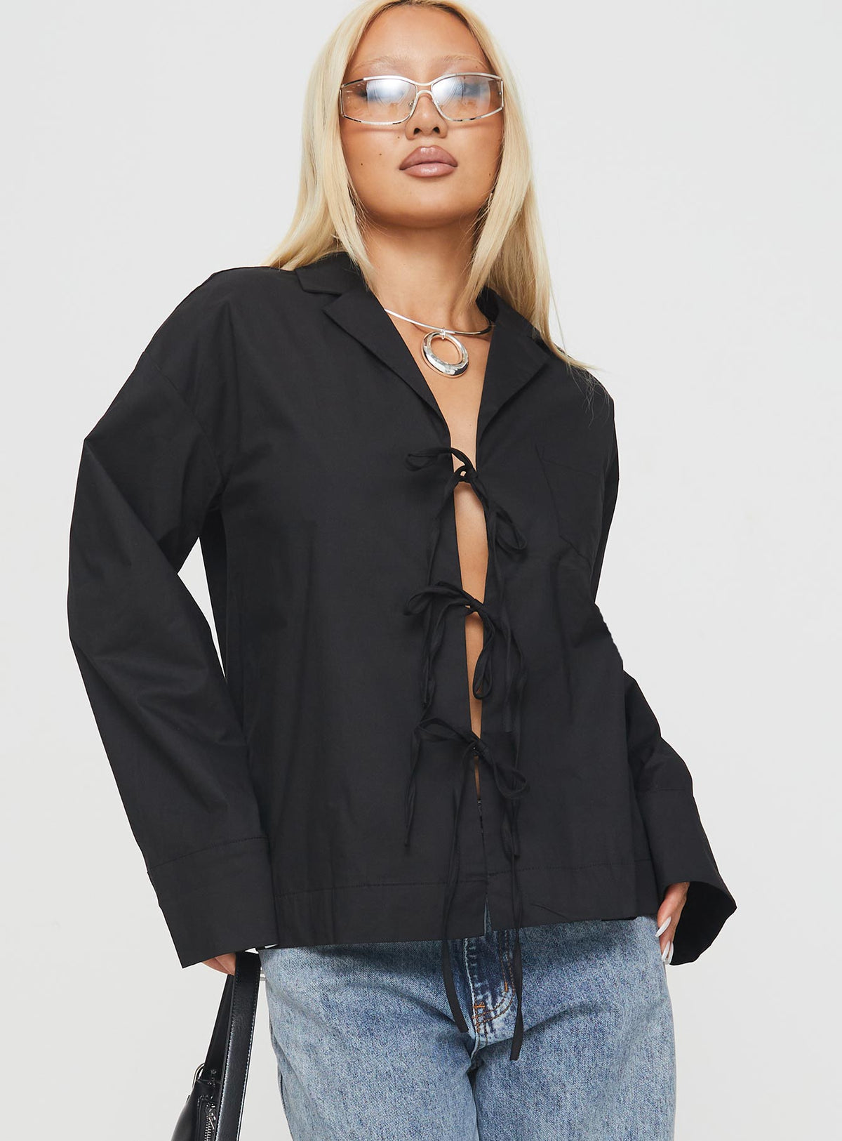 side view of model wearing Princess Polly Spiri Shirt Black Full Sleeves V-Neck 