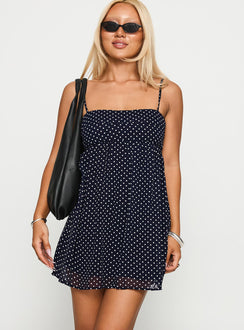 front view of model wearing Princess Polly Ortega Mini Dress Navy Polka Square Neck 