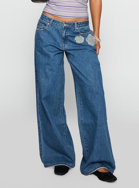 front view of model wearing Princess Polly A Keeper Flower Patch Low Rise Wide Leg Jeans Mid Blue Low Rise Jeans Jeans 