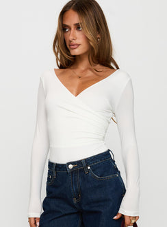 side view of model wearing Princess Polly Right Here Cross Detail Bodysuit White Long Sleeve Tops Bodysuit 