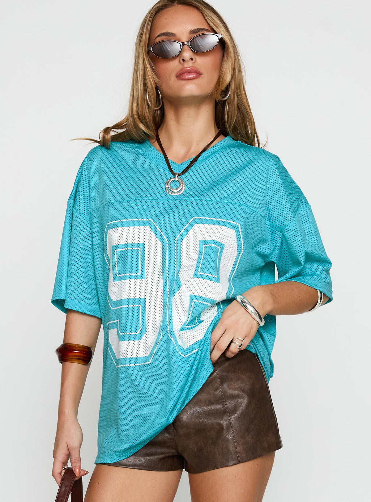 front view of model wearing Princess Polly 98 Sports Graphic Top Blue Half Sleeves V-Neck 