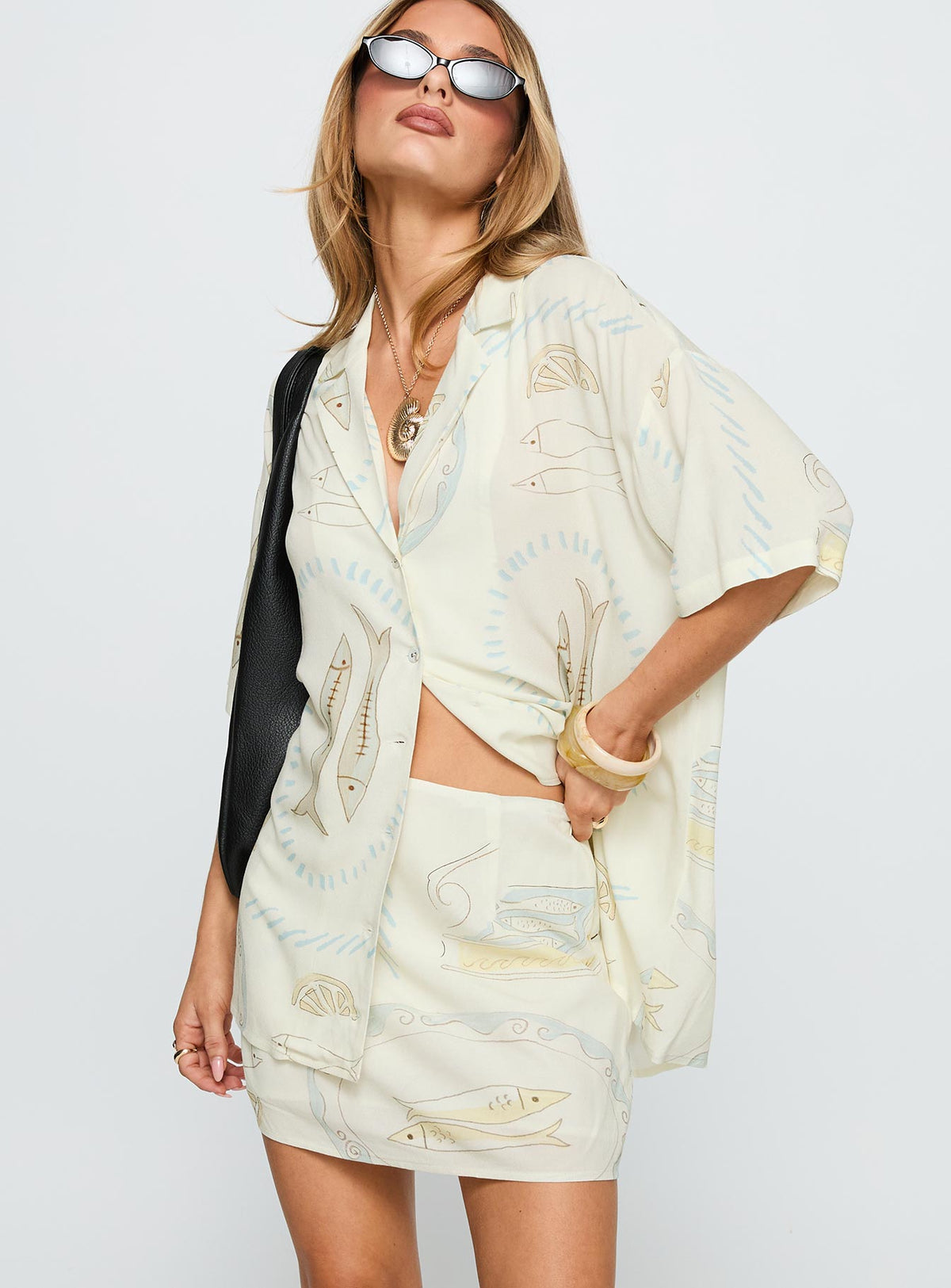   side view of model wearing Princess Polly Caraliia Mini Skirt Cream Mini Skirts Skirts 