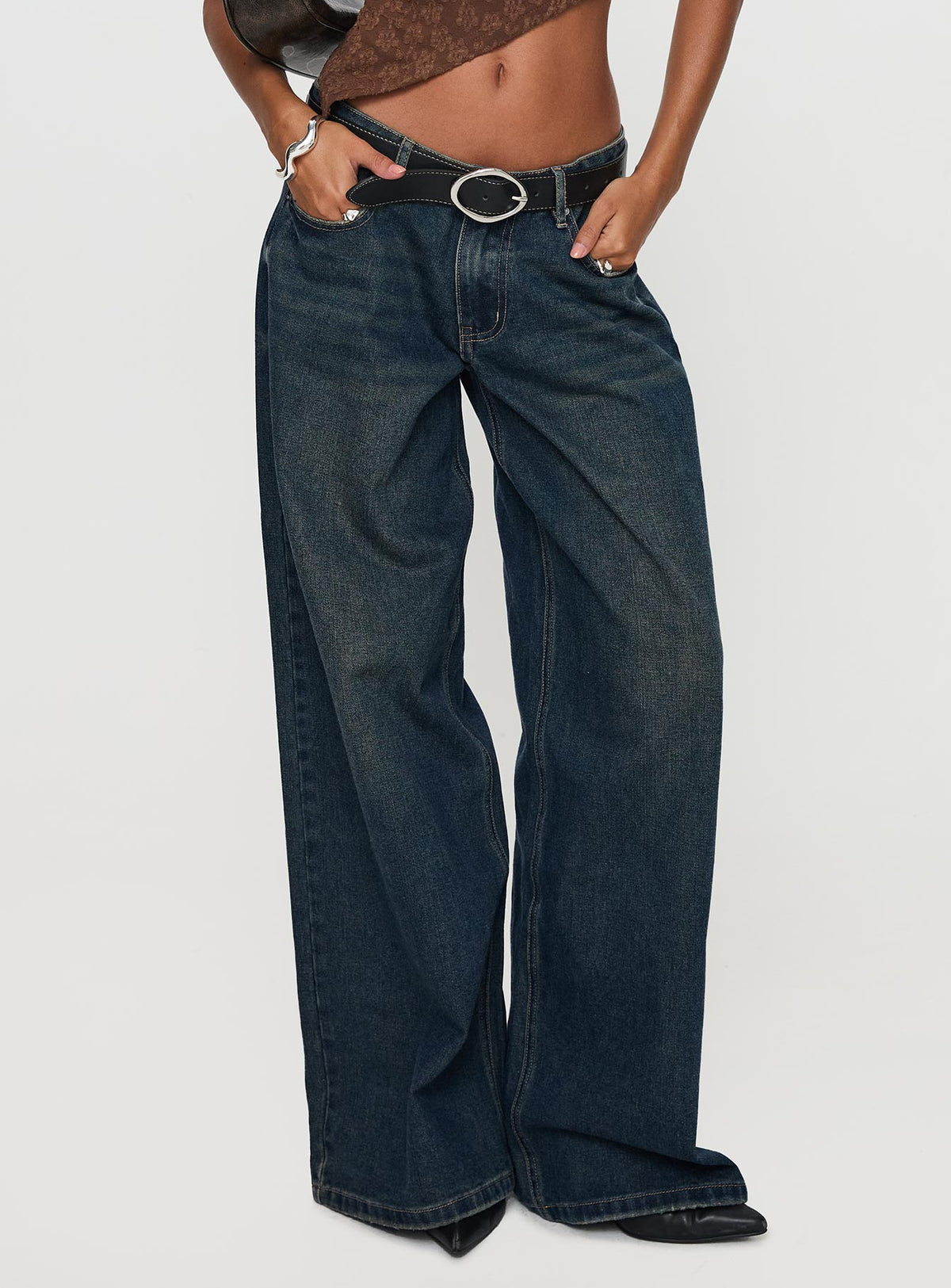 side view of model wearing Princess Polly Low Rise Wide Leg Jean Hocus Pocus Wash Low Rise Jeans 