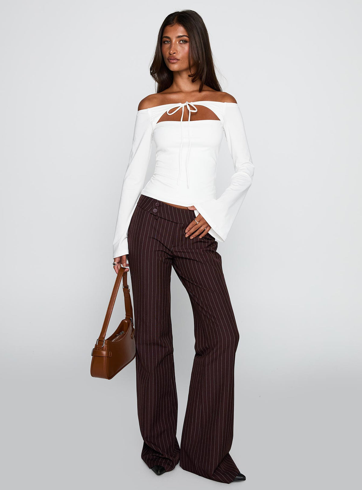 front view of model wearing Princess Polly Kinkirk Flared Pants Brown Pinstripe Low Rise Pants Pants 