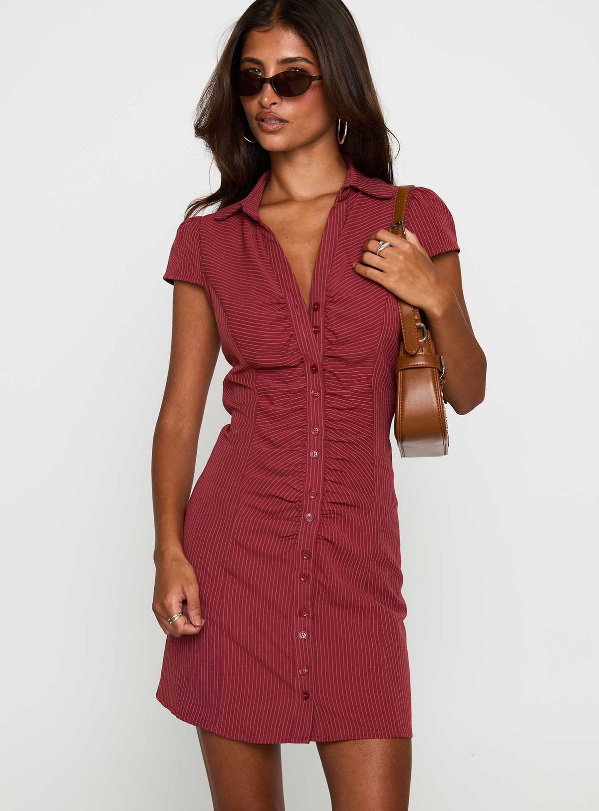side view of model wearing Princess Polly Arianwyn Mini Dress Burgundy V-Neck 