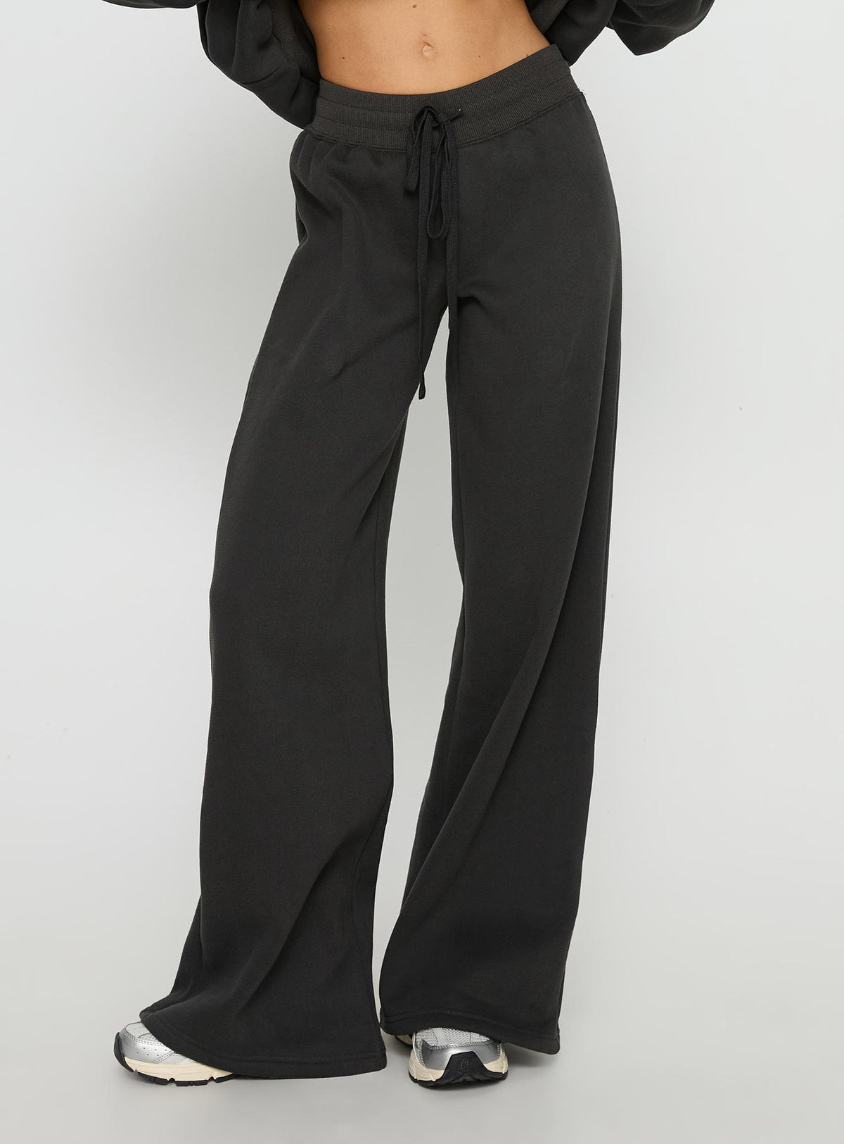 side view of model wearing Princess Polly Princess Polly Stargirl Wide Leg Sweat Pants Charcoal High Rise Pants Pants 