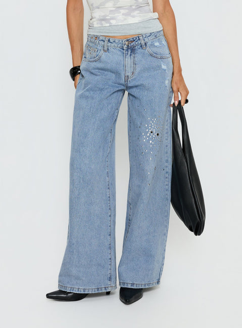 Showcasing Candi Mid Rise Wide Leg Studded Jeans in a light blue wash, womens-jeans featuring mid-rise waist front view of model wearing Princess Polly