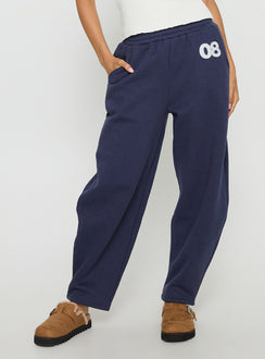 side view of model wearing Princess Polly Route 08 Barrel Track Pant Navy Mid Rise Pants Pants 