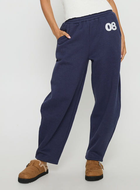 side view of model wearing Princess Polly Route 08 Barrel Track Pant Navy Mid Rise Pants Pants 