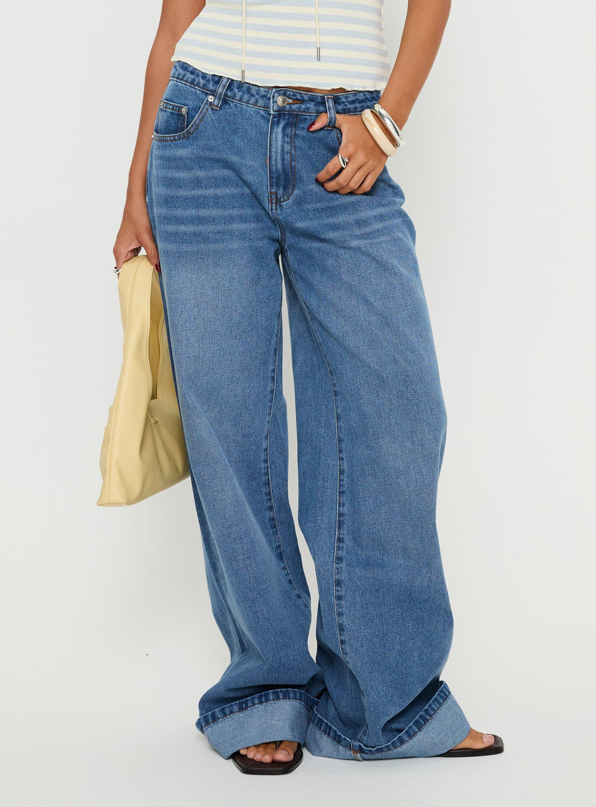 side view of model wearing Princess Polly Jacobie Mid Rise Wide Leg Jeans Mid Blue Wash Mid Rise Jeans Jeans 