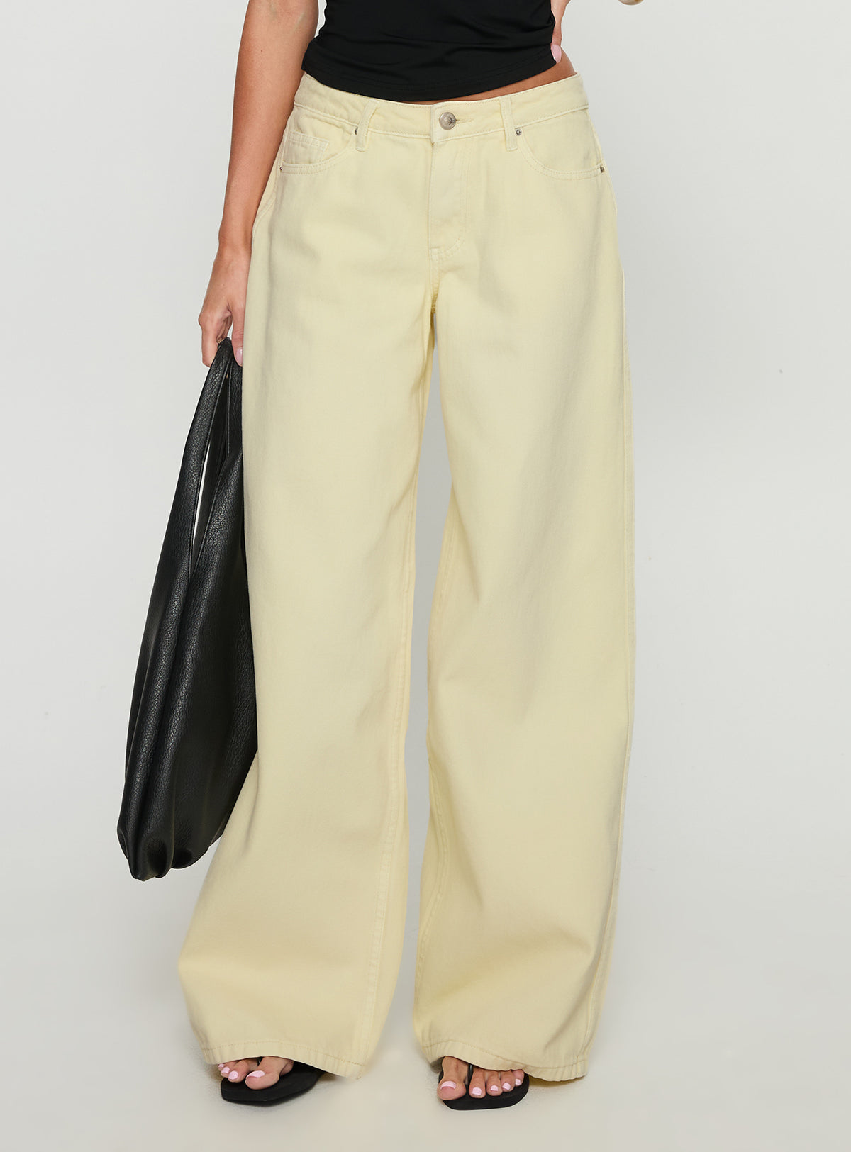 side view of model wearing Princess Polly Ramos Low Rise Wide Leg Denim Jeans Butter Lemon Low Rise Jeans Jeans 