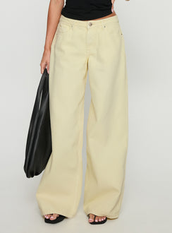 side view of model wearing Princess Polly Ramos Low Rise Wide Leg Denim Jeans Butter Lemon Low Rise Jeans Jeans 