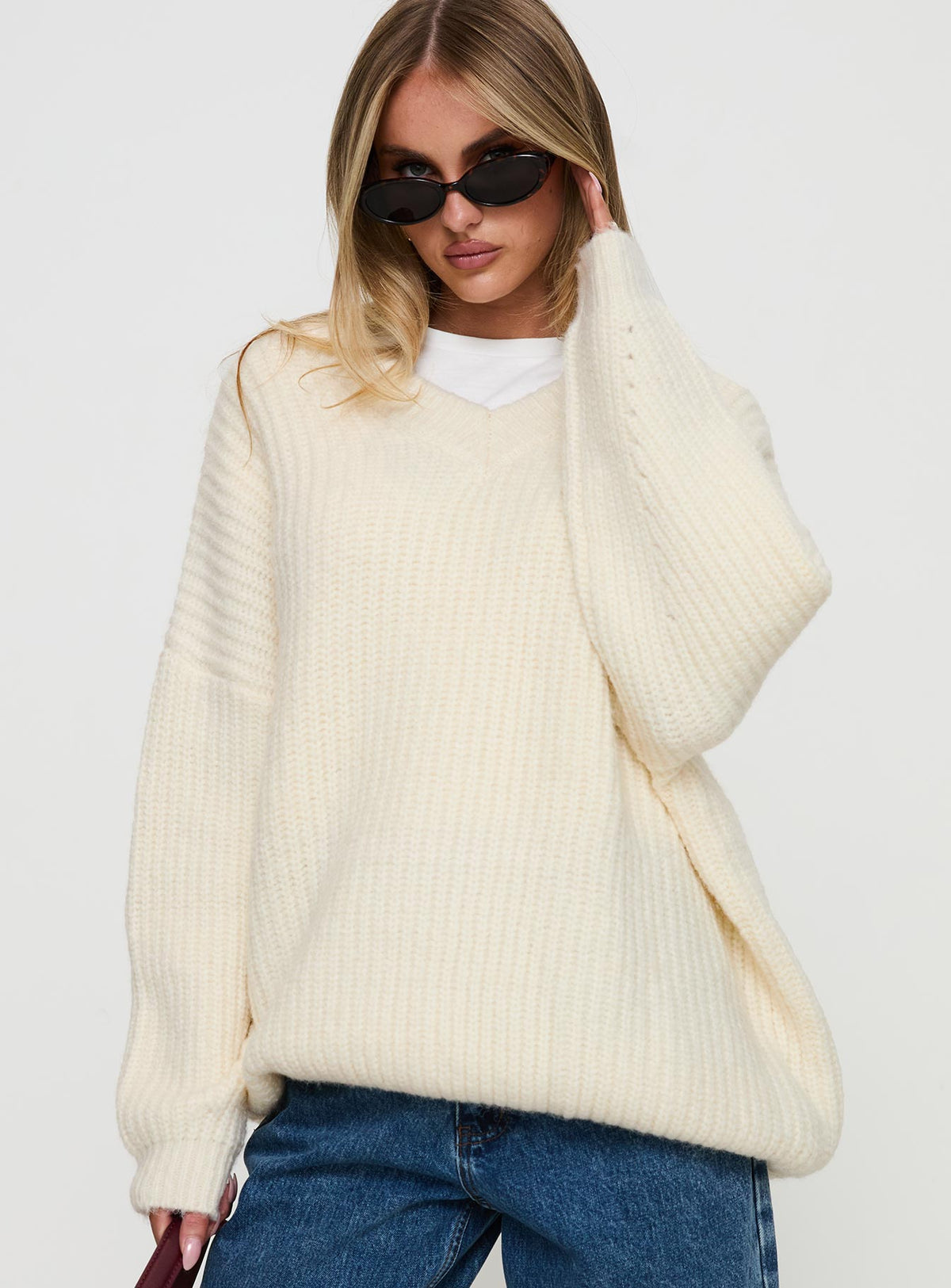 side view of model wearing Princess Polly Have It All V Neck Knit Sweater Cream Long 