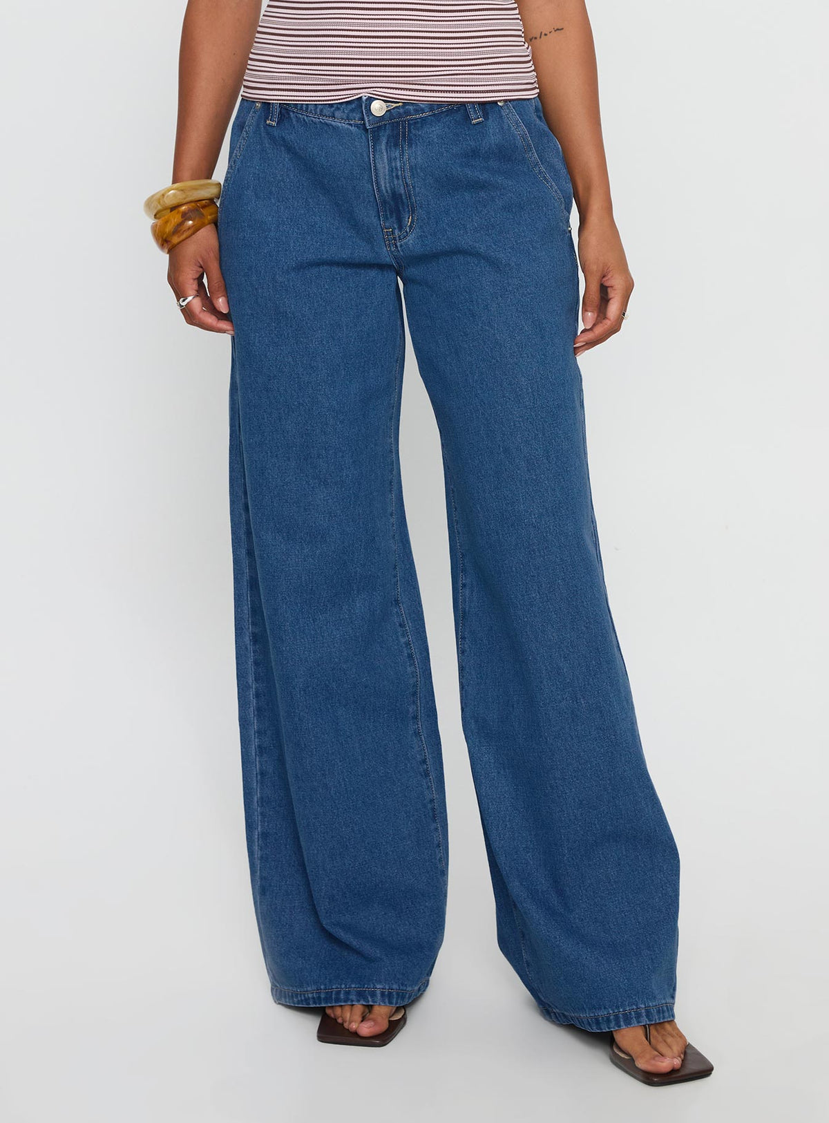 front view of model wearing Princess Polly Polaris Mid Rise Straight Leg Jeans Mid Blue Mid Rise Jeans Jeans 