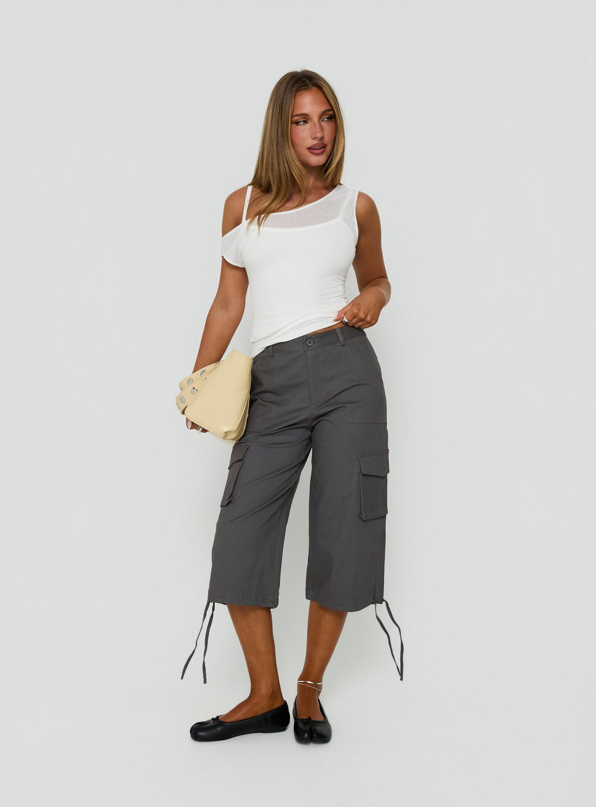 Showcasing the Alfonza Utility Capri in Slate womens-regular-pants with mid-rise cargo design side view of model wearing Princess Polly