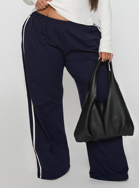 back view of model wearing Princess Polly Circuit Track Pants Navy Curve Pants 