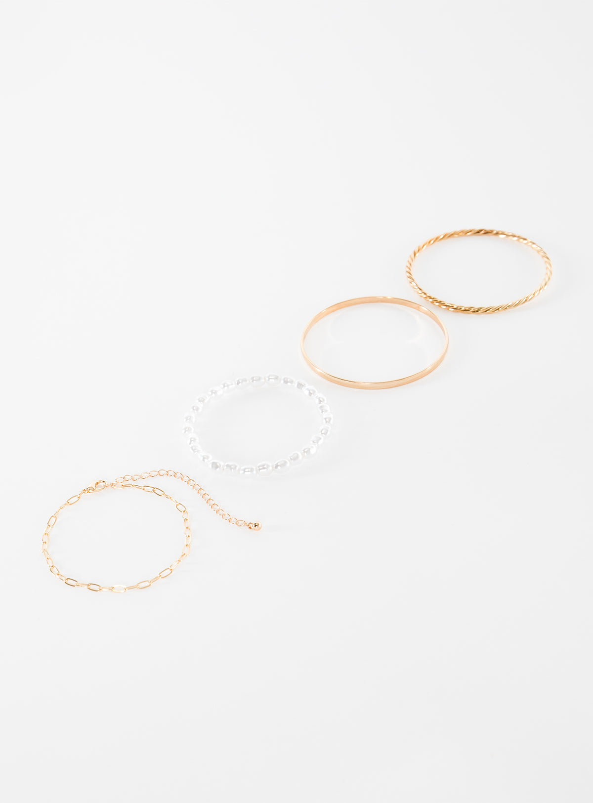 Gold-toned bracelet pack Four separate bracelets, chain and bangle style, pearl detail, lightweight 