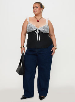 side view of model wearing Princess Polly Delvonte Top Black Curve Sleeveless Plunger 