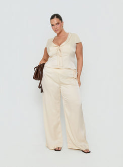 Featuring the Aubrette Satin Tie Pants Cream Curve womens-regular-pants designed with high-rise waist, belt and wide-leg style front view of model wearing Princess Polly
