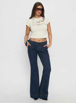 side view of model wearing Princess Polly Acapulco Low Rise Flare Jeans Dark Blue Wash Low Rise Jeans Jeans 