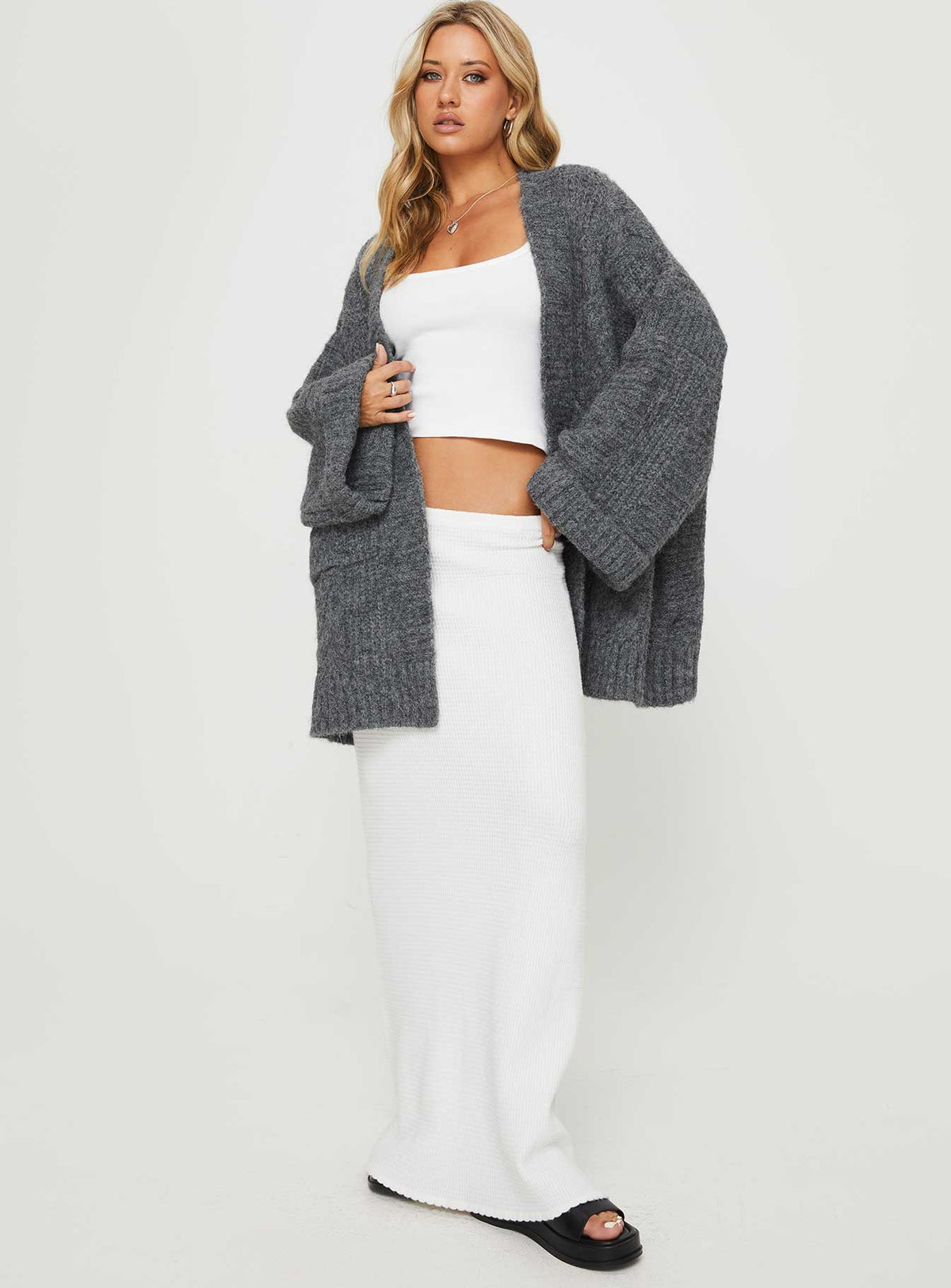 Discover the Paisleigh Cable Knit Cardigan Charcoal womens jumpers in long length detail view of model wearing Princess Polly